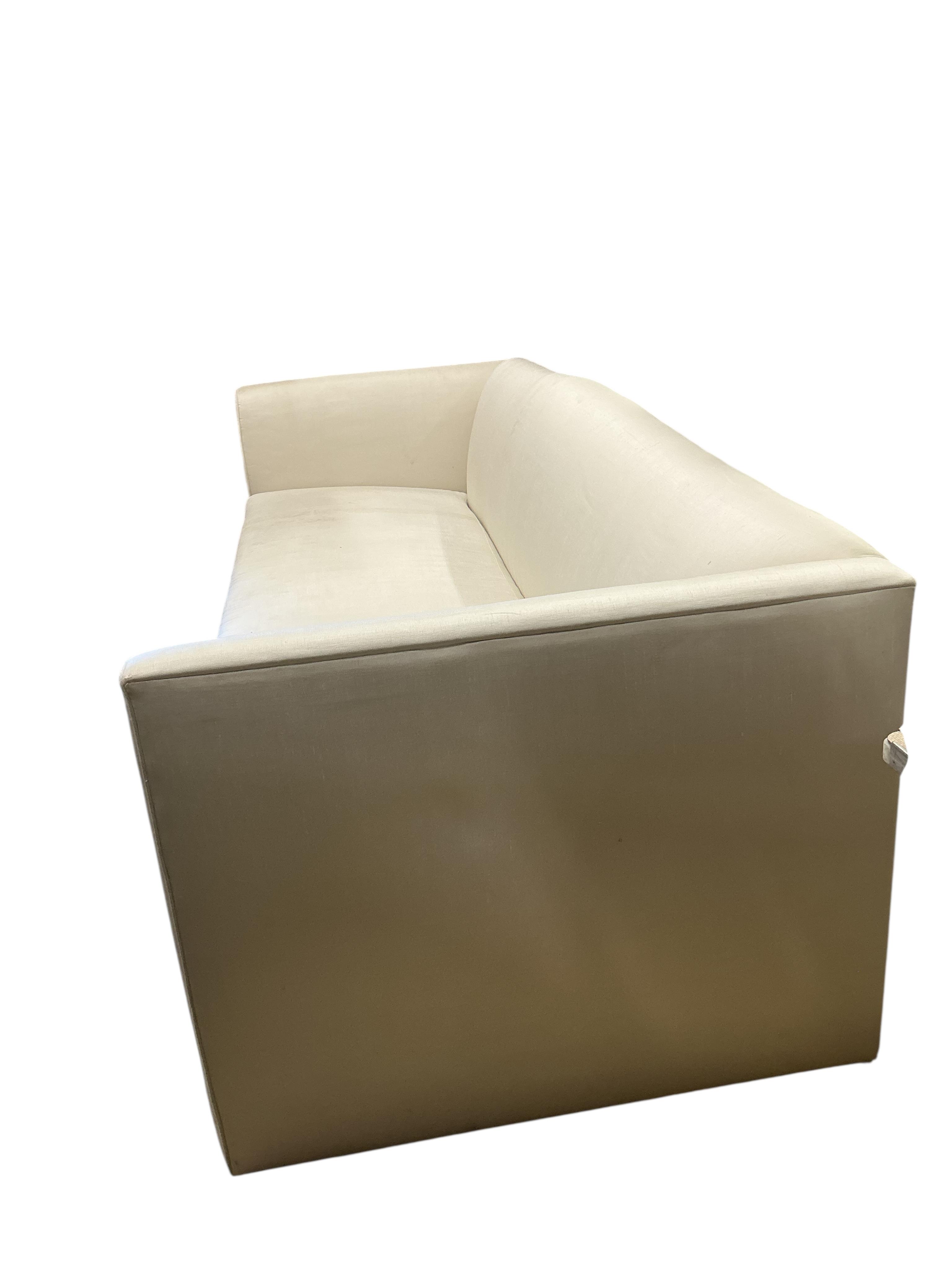 A large contemporary ivory fabric settee, width 260cm, depth 100cm, height 82cm